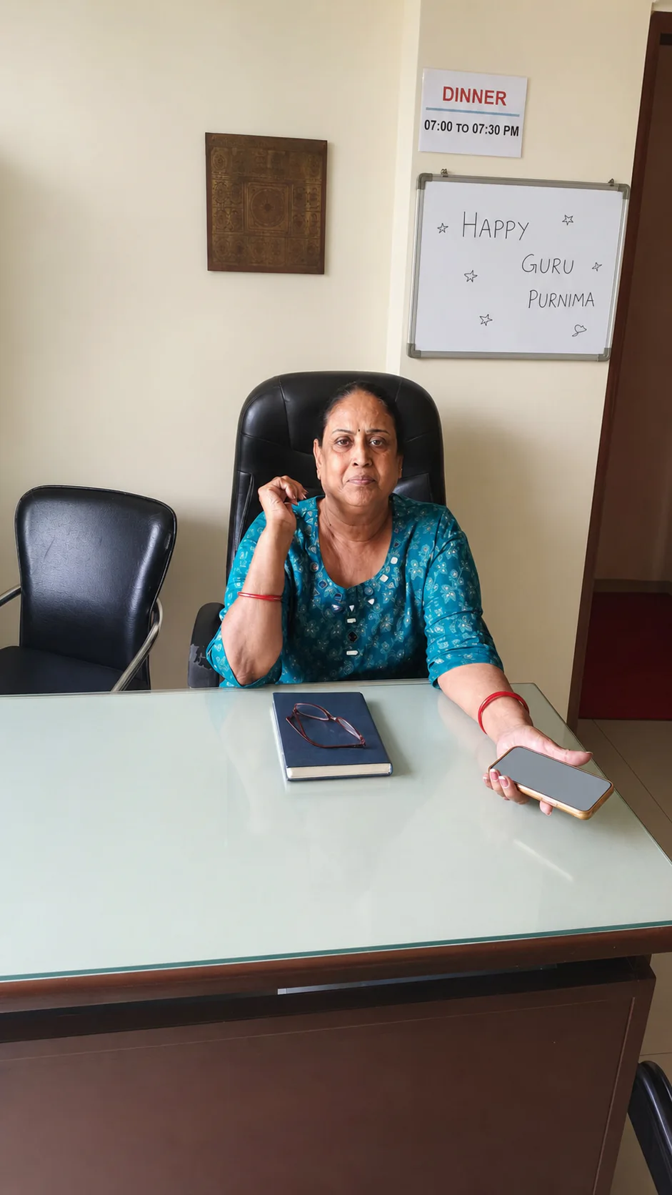 PJ PG co-owner in a teal kurta seated at the front desk