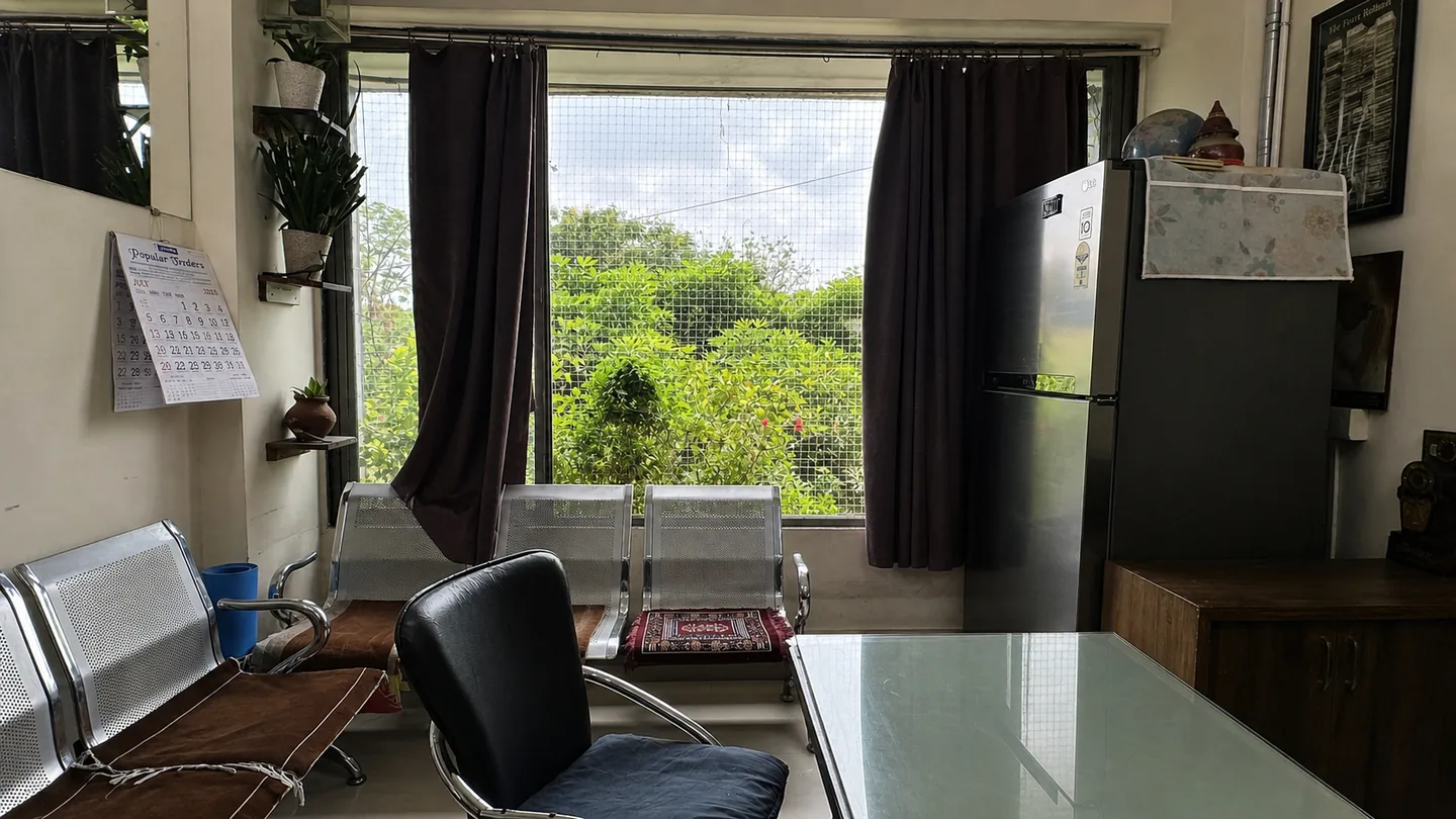 PJ PG common sitting area with chairs, table and refrigerator