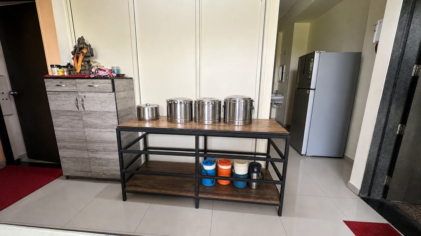 Dining and storage area with metal food containers and a refrigerator